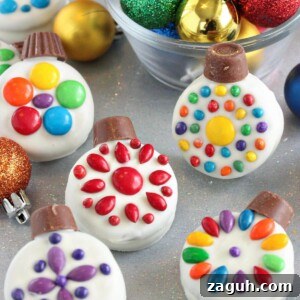 DIY Oreo Cookie Christmas Ornaments: Festive Homemade Ideas 12 Oreo Cookie Christmas Ornaments on a glittery background with colorful ornaments in a bowl behind them.
