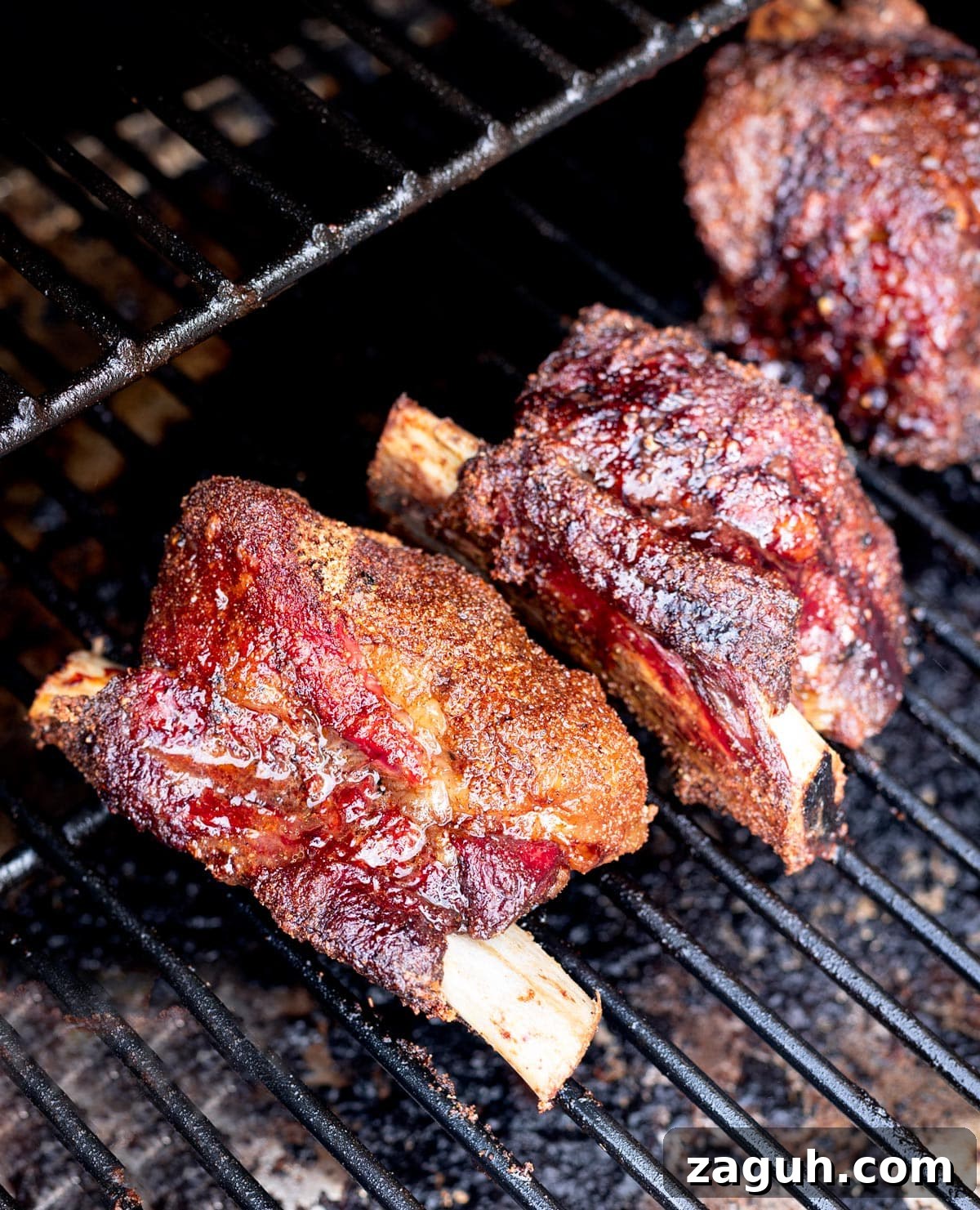 Perfectly Smoked Beef Short Ribs: Tender BBQ Recipe 12 Close up of short ribs on smoker racks.