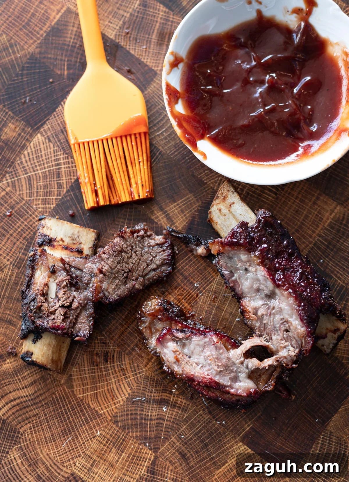 Perfectly Smoked Beef Short Ribs: Tender BBQ Recipe 14 Person lathering on bbq sauce to smoked short ribs.