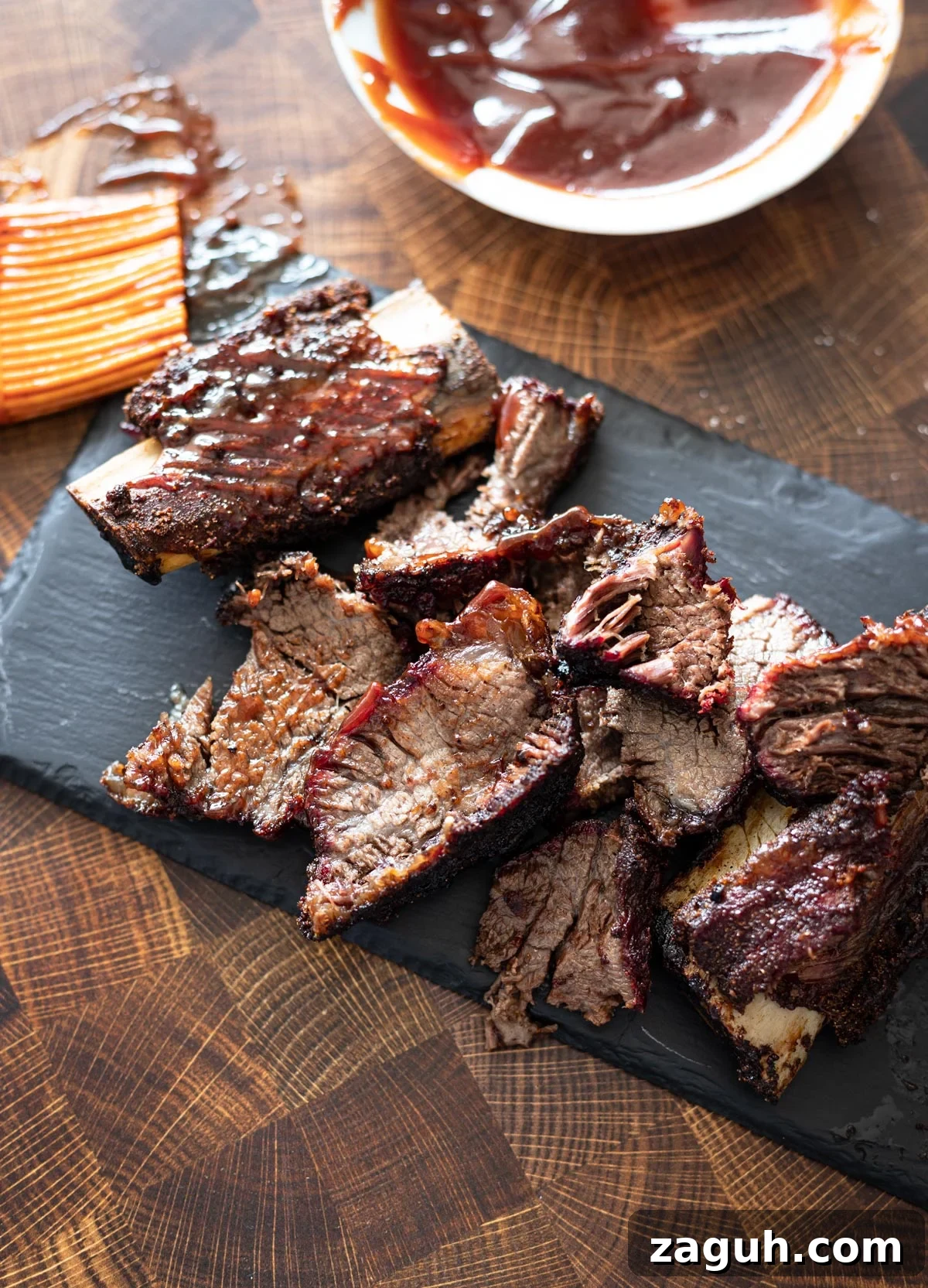 Perfectly Smoked Beef Short Ribs: Tender BBQ Recipe 3 Sliced short ribs lathered in BBQ sauce.