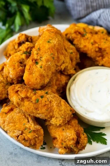 Crispy Southern Fried Pickles Recipe for Ultimate Crunch 6 A plate of fried chicken wings served with ranch dip.