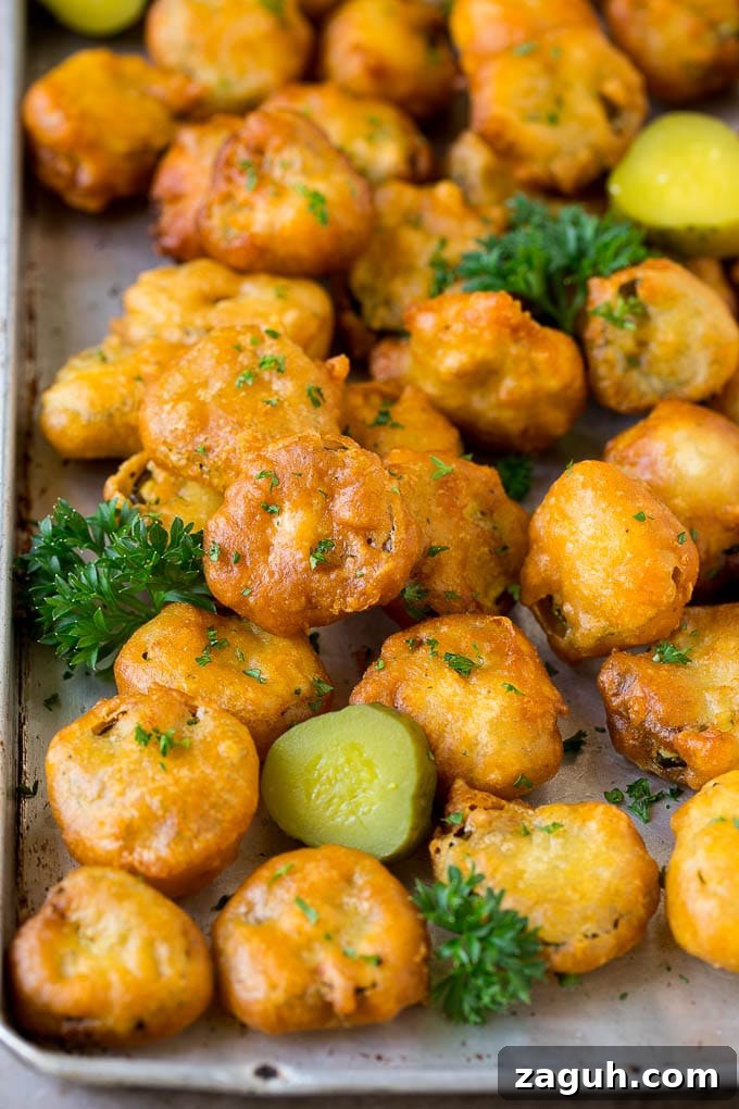 Fried Pickles Garnished Fried pickles on a sheet pan, garnished with parsley.
