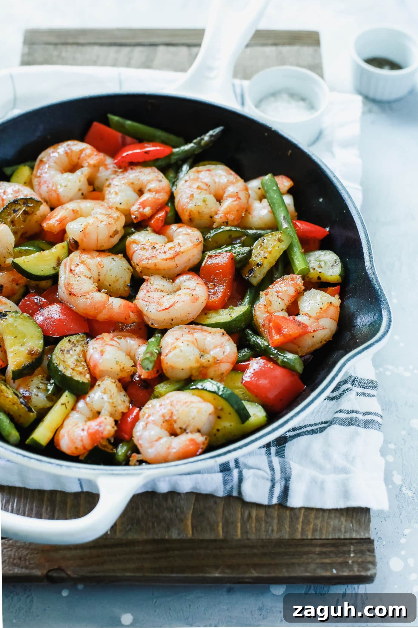 15 Whole30 Meal-Prep Recipes for Stress-Free Weekly Planning 15 Shrimp, zucchini, asparagus, and red bell peppers in a cast-iron skillet.