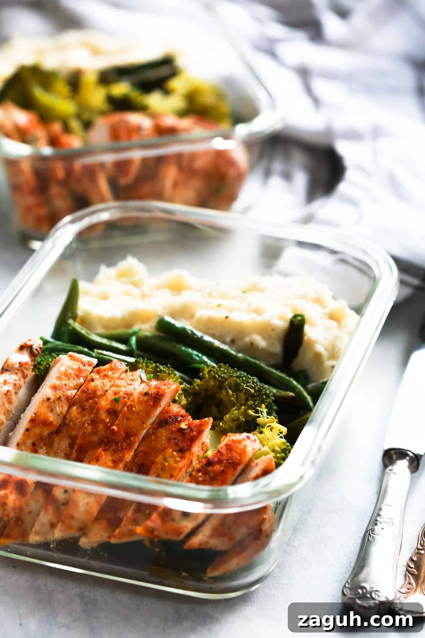 15 Whole30 Meal-Prep Recipes for Stress-Free Weekly Planning 5 Spicy chicken, broccoli, green beans, and mashed cauliflower in a glass container.