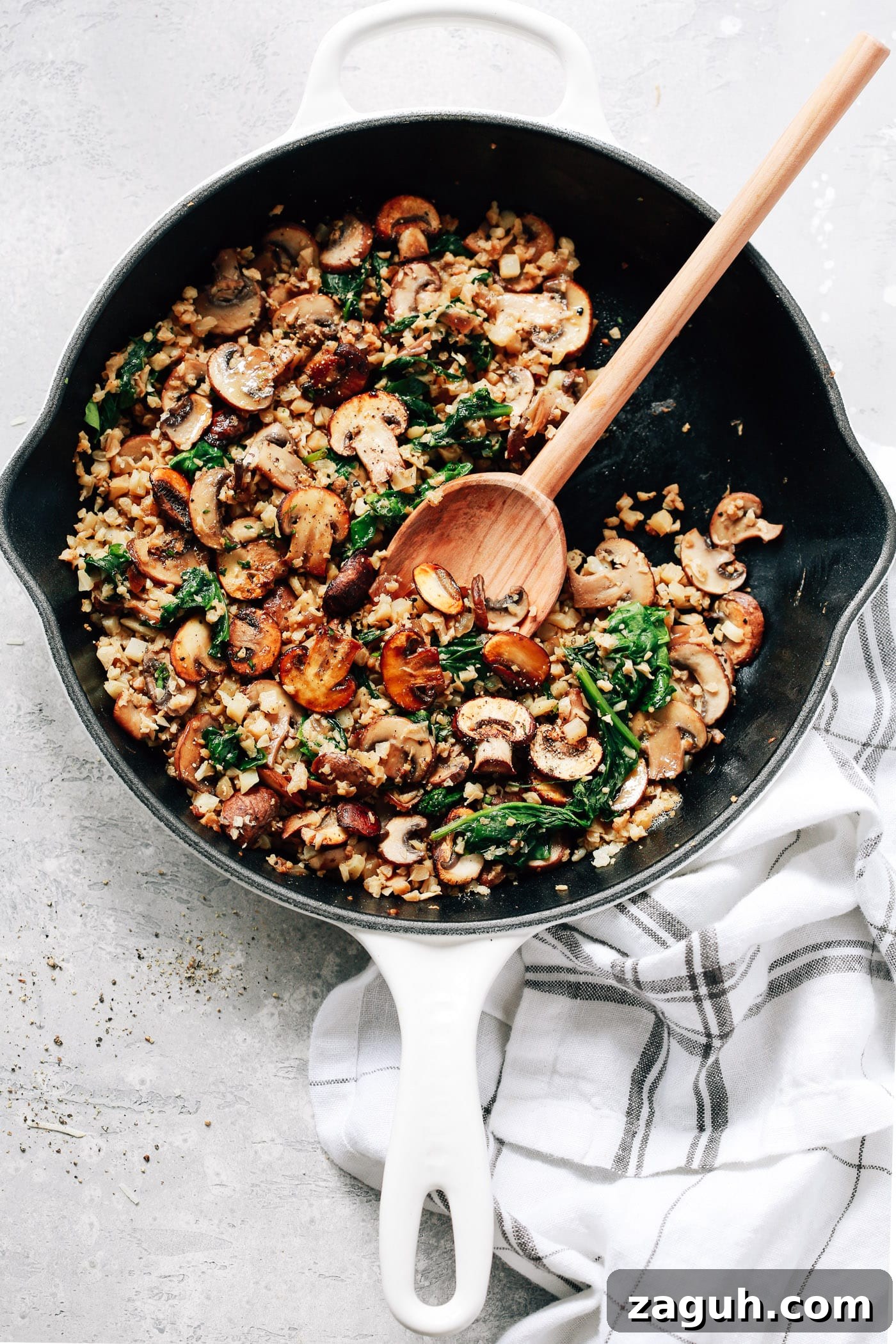 15 Whole30 Meal-Prep Recipes for Stress-Free Weekly Planning 10 An overhead view of a white skillet containing Mushroom Cauliflower Rice.