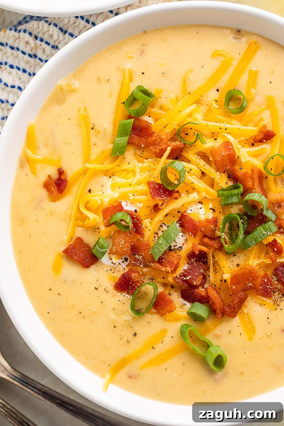 Creamy Gluten-Free Potato Soup Recipe for Cozy Weeknights 2 Close-up of gluten free potato soup in a large white soup bowl.