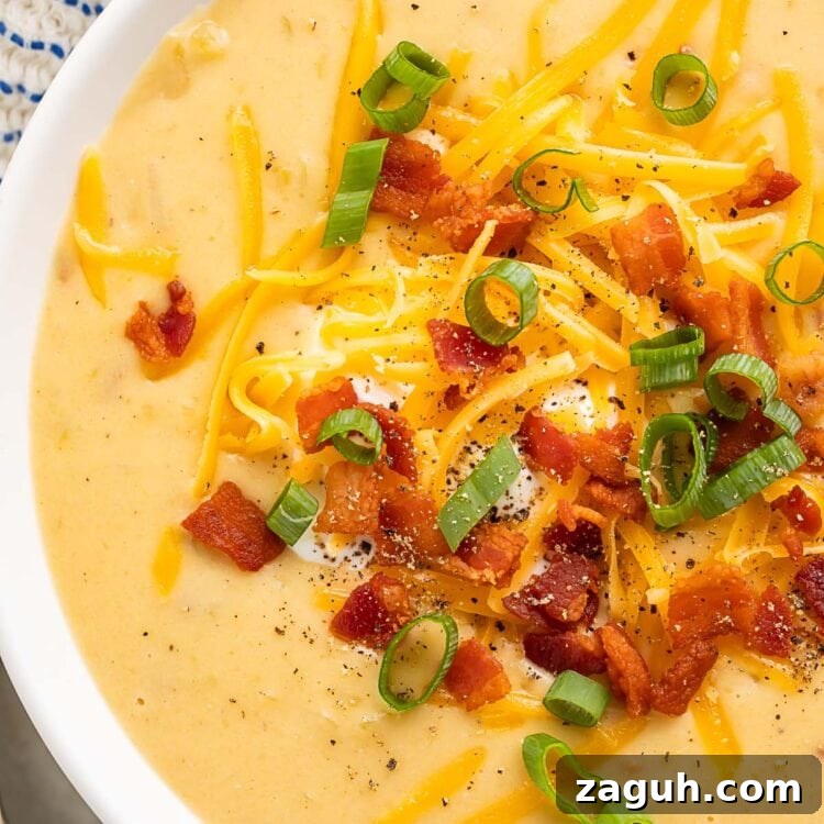 Creamy Gluten-Free Potato Soup Recipe for Cozy Weeknights 4 Close-up of gluten free potato soup in a large white soup bowl.