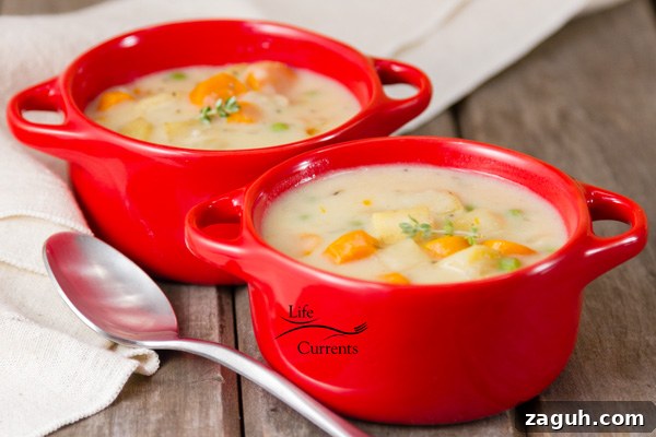 Slow Cooker Creamy Vegetable Pot Pie Recipe 8 Two red bowls filled with pot pie soup.
