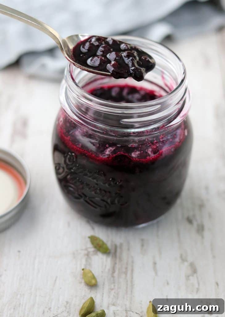 Swedish Pancakes with Vanilla Pastry Cream & Blueberry-Cardamom Compote 7 Blueberry compote in a jar with a spoon