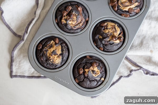 Banana Chocolate Chip Muffins with Oats and Greek Yogurt 4 chocolate chip banana muffins in muffin pan