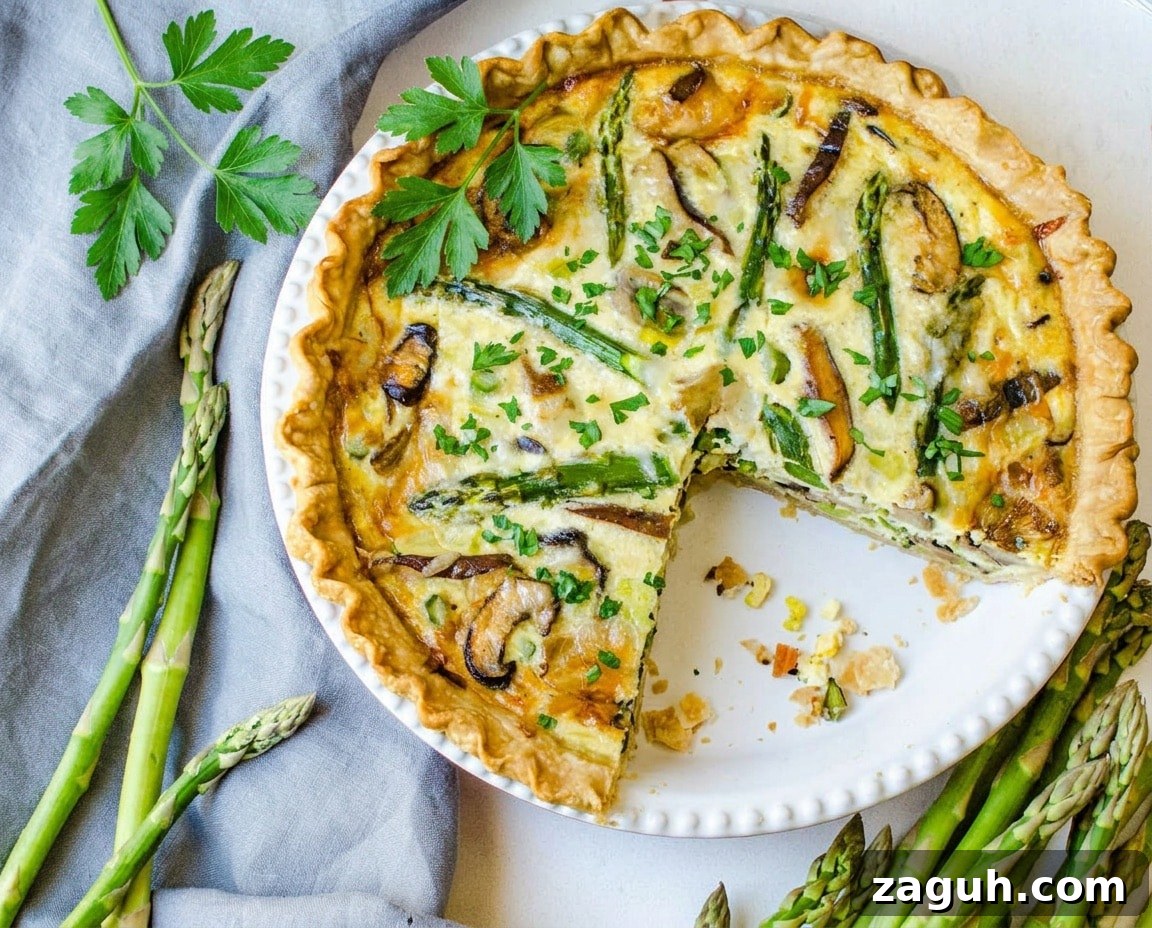 Asparagus, Mushroom & Gruyère Quiche with Leeks for Spring Brunch 2 Asparagus quiche with a slice taken out.