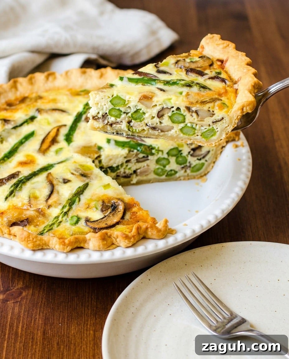 Asparagus, Mushroom & Gruyère Quiche with Leeks for Spring Brunch 7 Cutting a slice of the quiche.