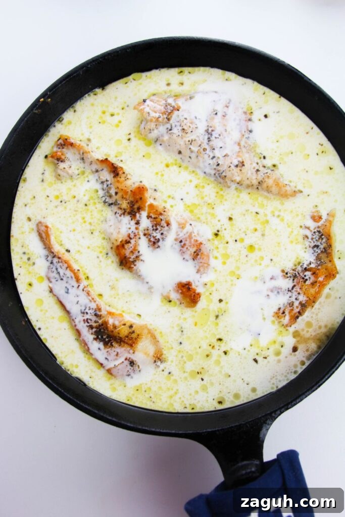 Tuscan-Style Creamy Garlic Chicken with Sun-Dried Tomatoes 8 overhead look of skillet with chicken and a cream sauce in the pan