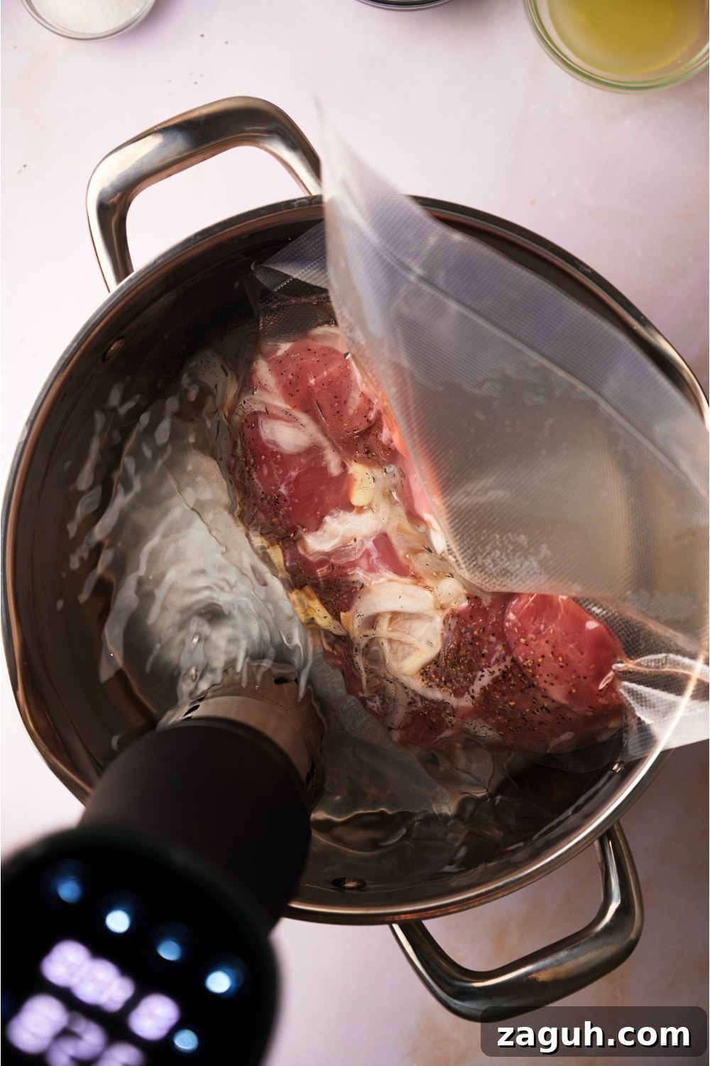 Juicy Sous Vide Pork Tenderloin Recipe — Perfectly Cooked Every Time 6 Sous vide pork tenderloin in a large pot filled with water and a sous vide machine in the pot.