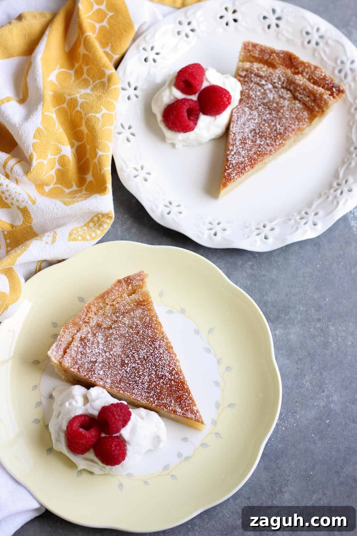 Classic Homemade Custard Pie Recipe for Rich, Creamy Filling 3 An overhead image of two custard tar slices with whipped cream and berries.