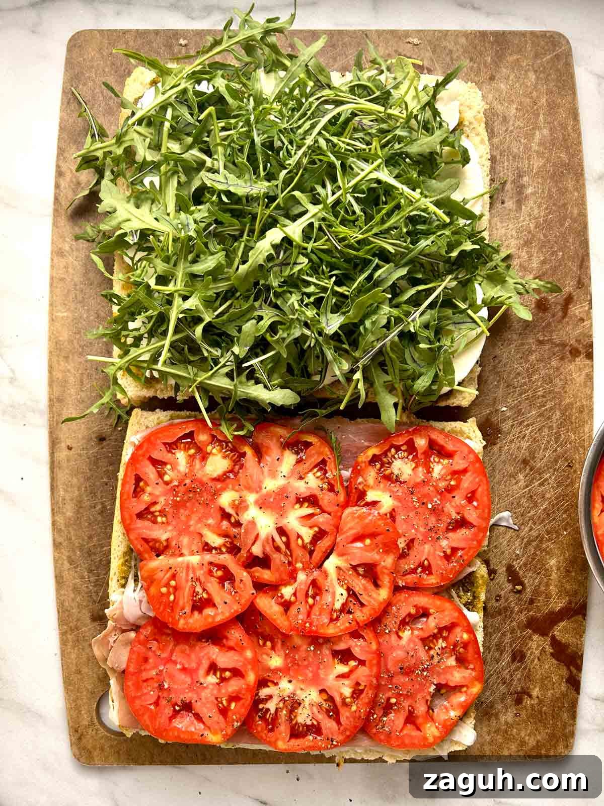 Focaccia Sandwich Recipes: Flavorful Ideas for Lunch & Picnics 6 arugula and tomatoes added to focaccia halves.