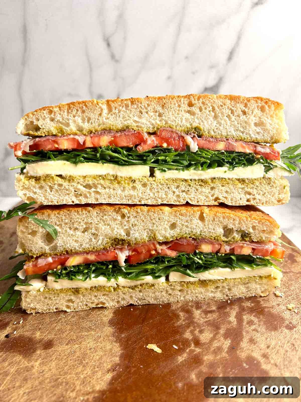 Focaccia Sandwich Recipes: Flavorful Ideas for Lunch & Picnics 7 focaccia sandwich cut in half and stacked on top of each other.