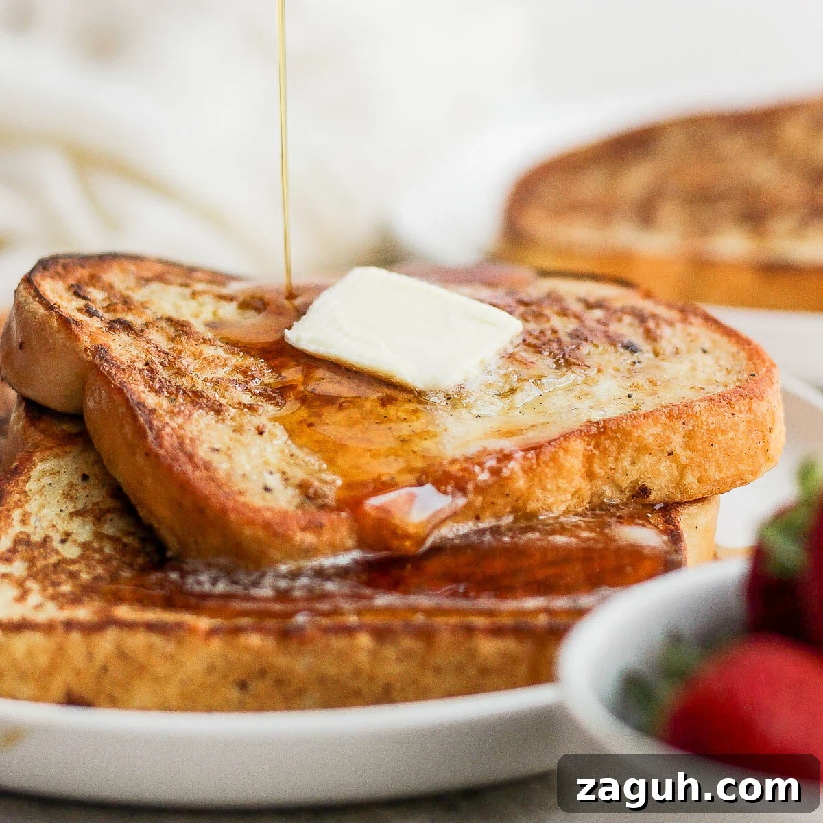 15-Minute Cinnamon French Toast Recipe for Busy Mornings 5 Drizzling syrup over French toast slices.
