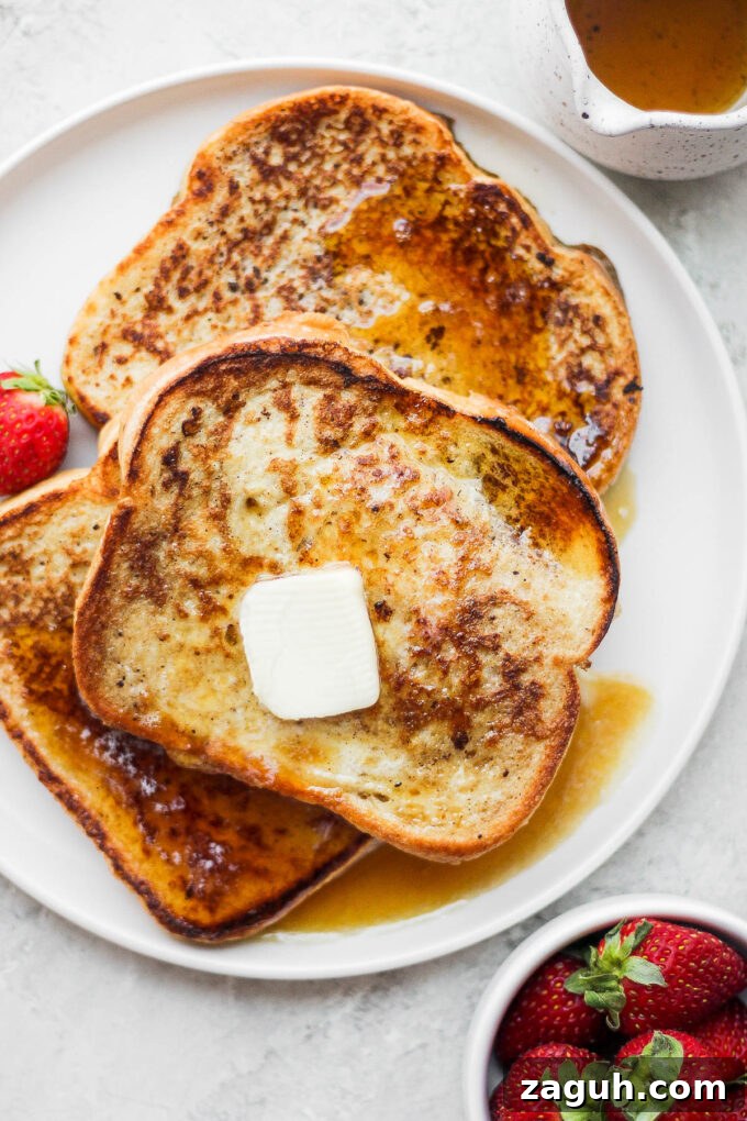 15-Minute Cinnamon French Toast Recipe for Busy Mornings 9 Slices of French toast on a white plate.