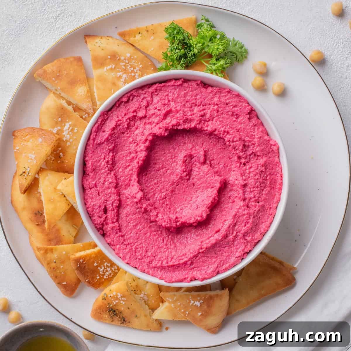 Creamy Beet Hummus Recipe with Garlic and Lemon 2 beetroot hummus served with pita chips.