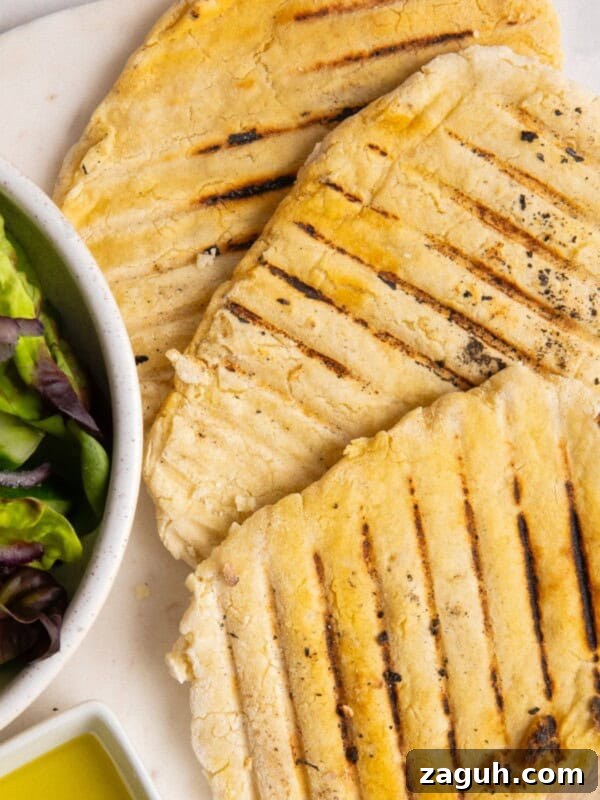 Creamy Beet Hummus Recipe with Garlic and Lemon 12 3 gluten free flatbreads on white plate.