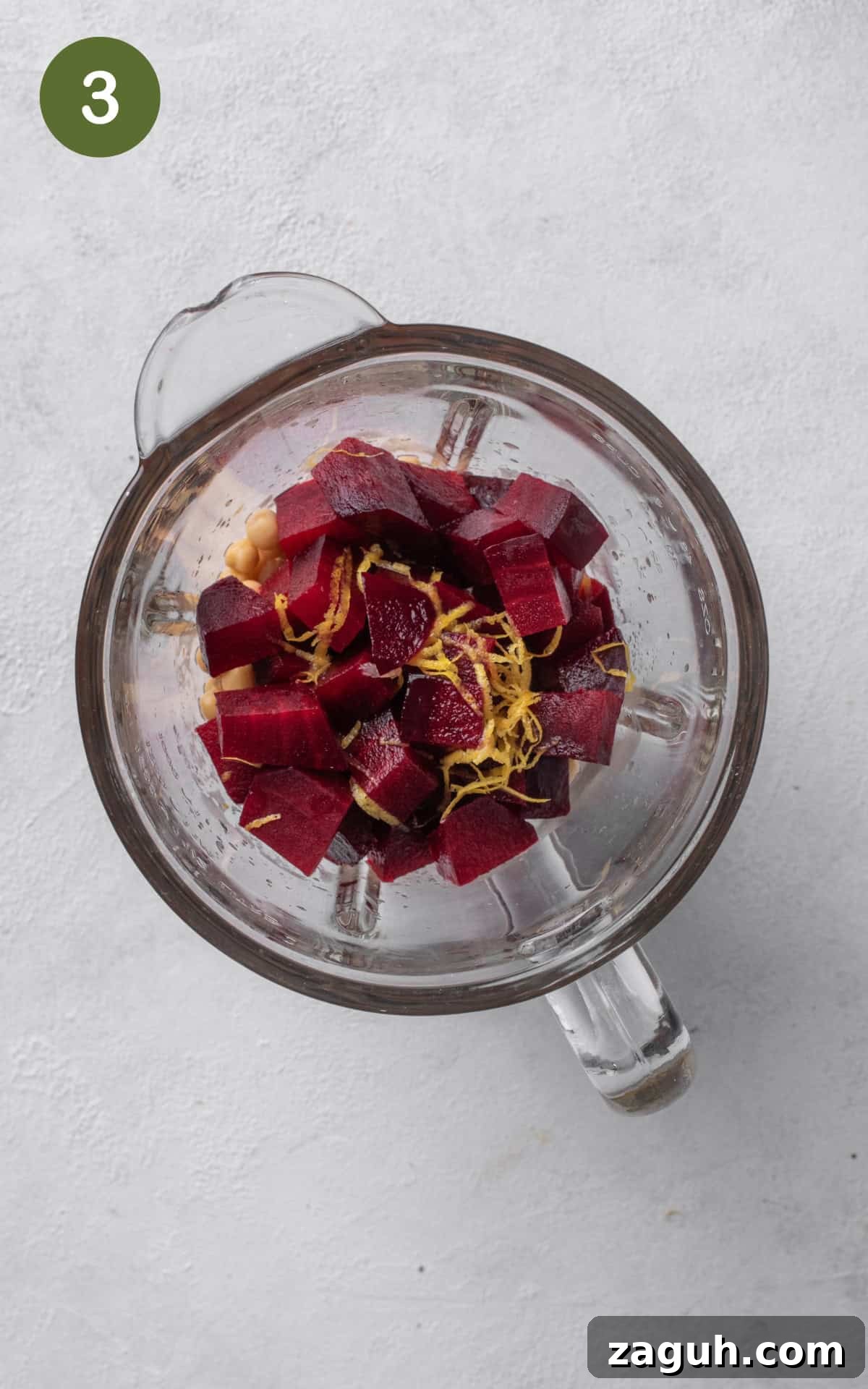 Creamy Beet Hummus Recipe with Garlic and Lemon 6 chickpeas, roasted beet, tahini, garlic, coriander, cumin, and salt in a high-power food blender.