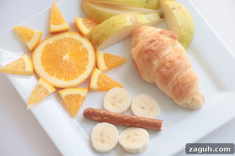 Butterfly Life Cycle Lunch Activity for Preschoolers (Video) 5 plate with fruit and croissant arranged to look like butterfly life cycle