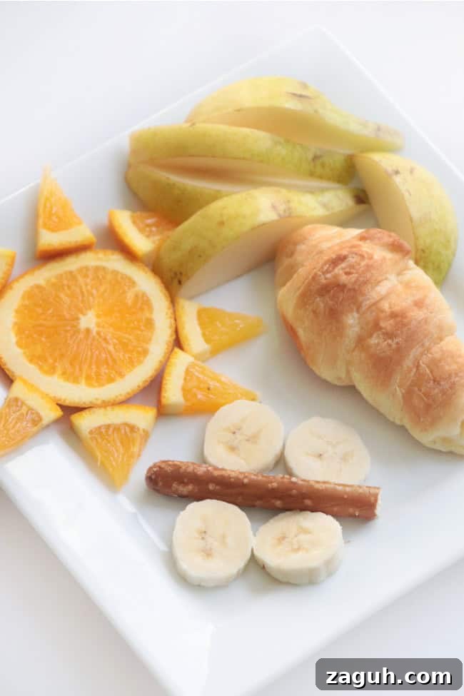 Butterfly Life Cycle Lunch Activity for Preschoolers (Video) 6 oranges, croissant, pretzel, banana slices and apples arranged on plate