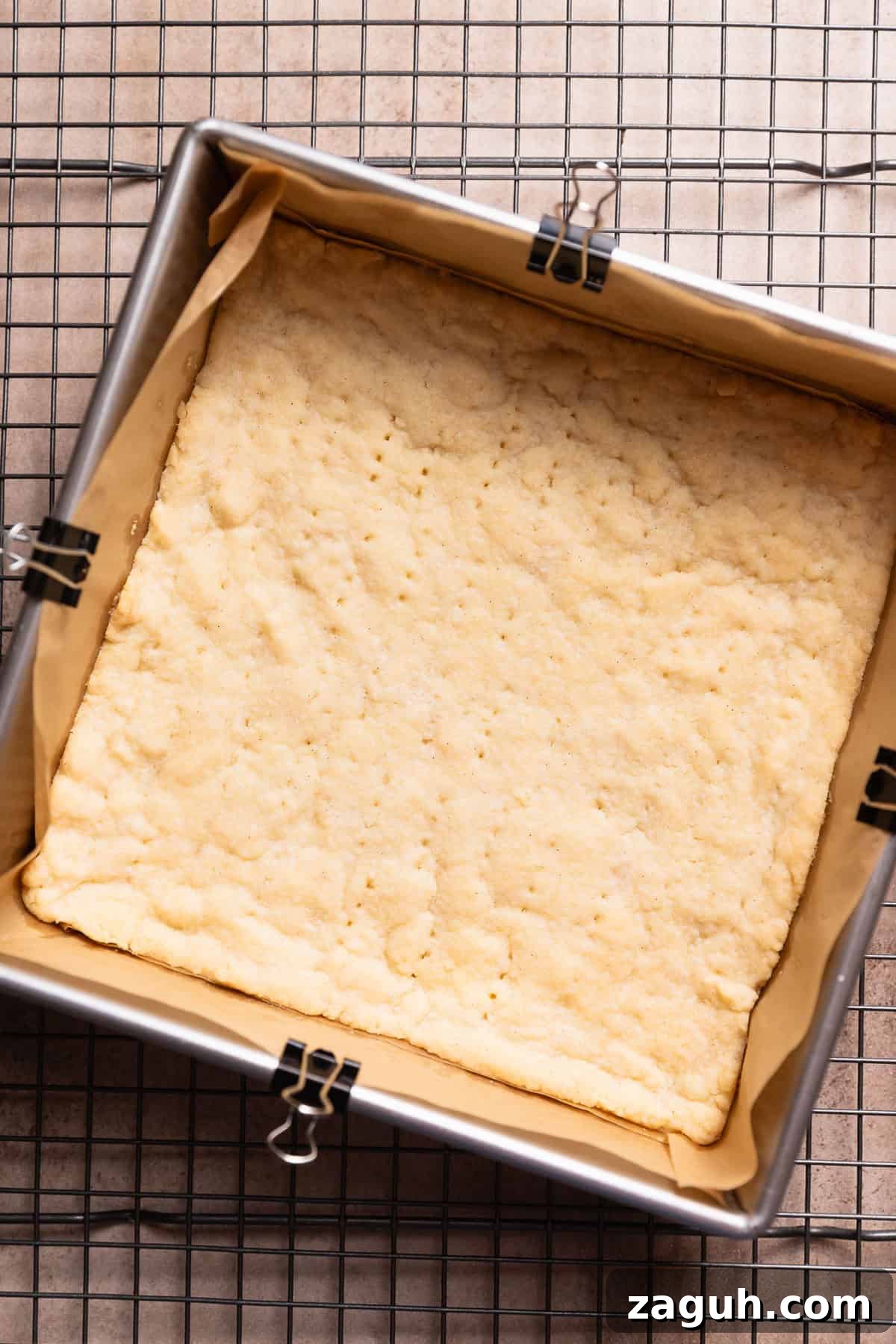 Tangy Lemon Bars with Buttery Shortbread Crust 5 A pan with the baked shortbread crust cooling on a wire rack.