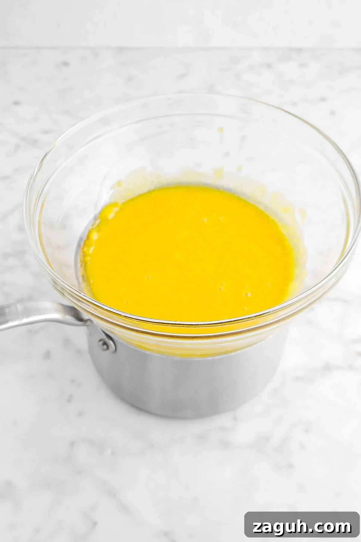 Authentic Italian Tiramisu Recipe: Step-by-Step Classic Guide 6 egg yolk mixture over pot of water on marble surface
