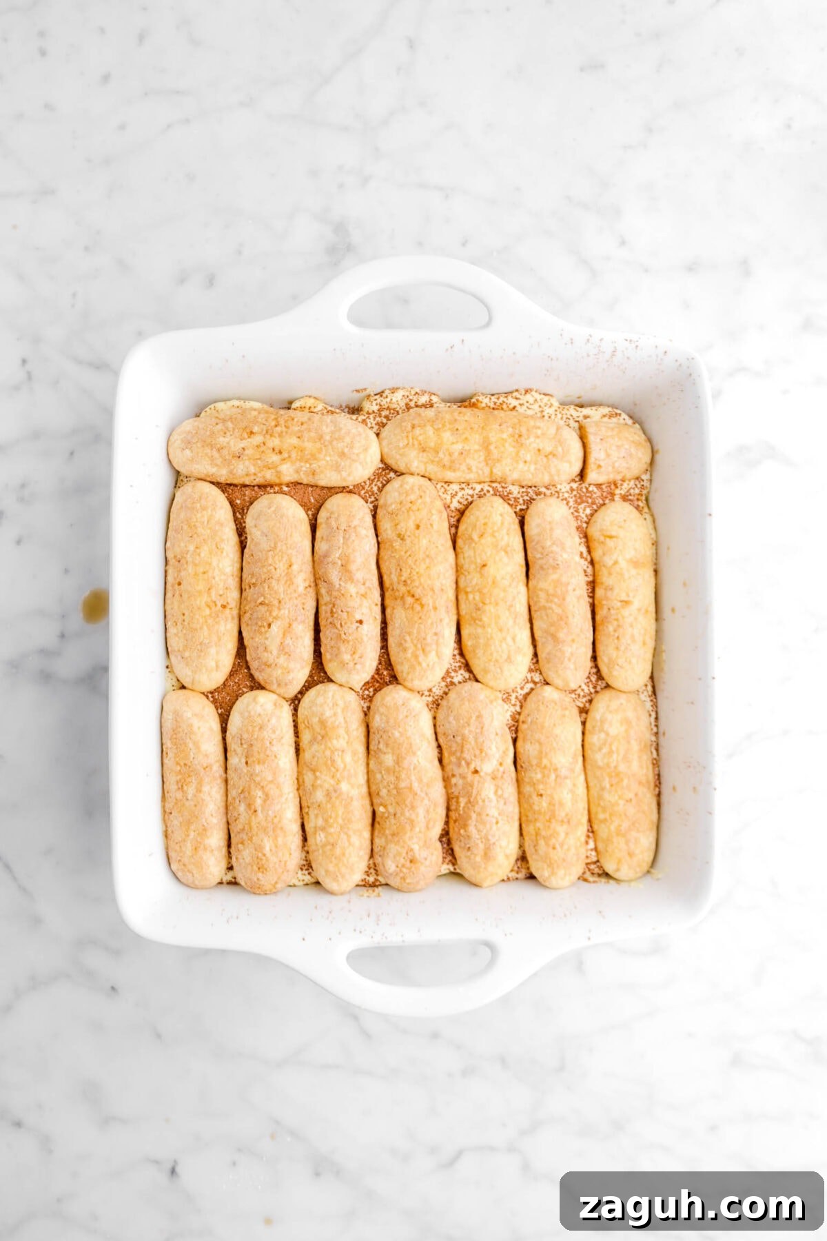 Authentic Italian Tiramisu Recipe: Step-by-Step Classic Guide 10 coffee soaked ladyfingers added on top of cocoa powder layer