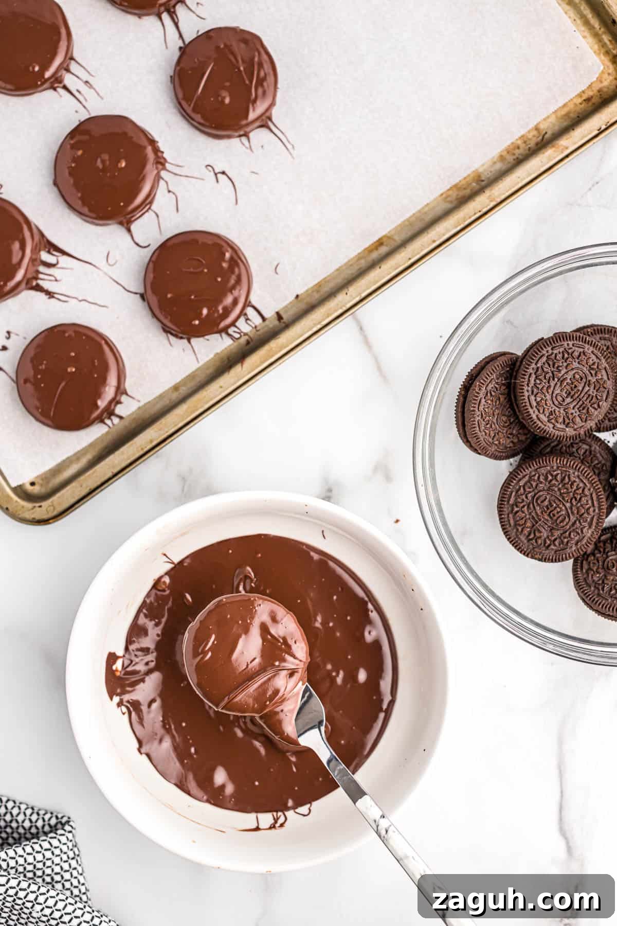 How to Make Chocolate-Covered Oreos at Home 5 dipping an oreo into melted chocolate