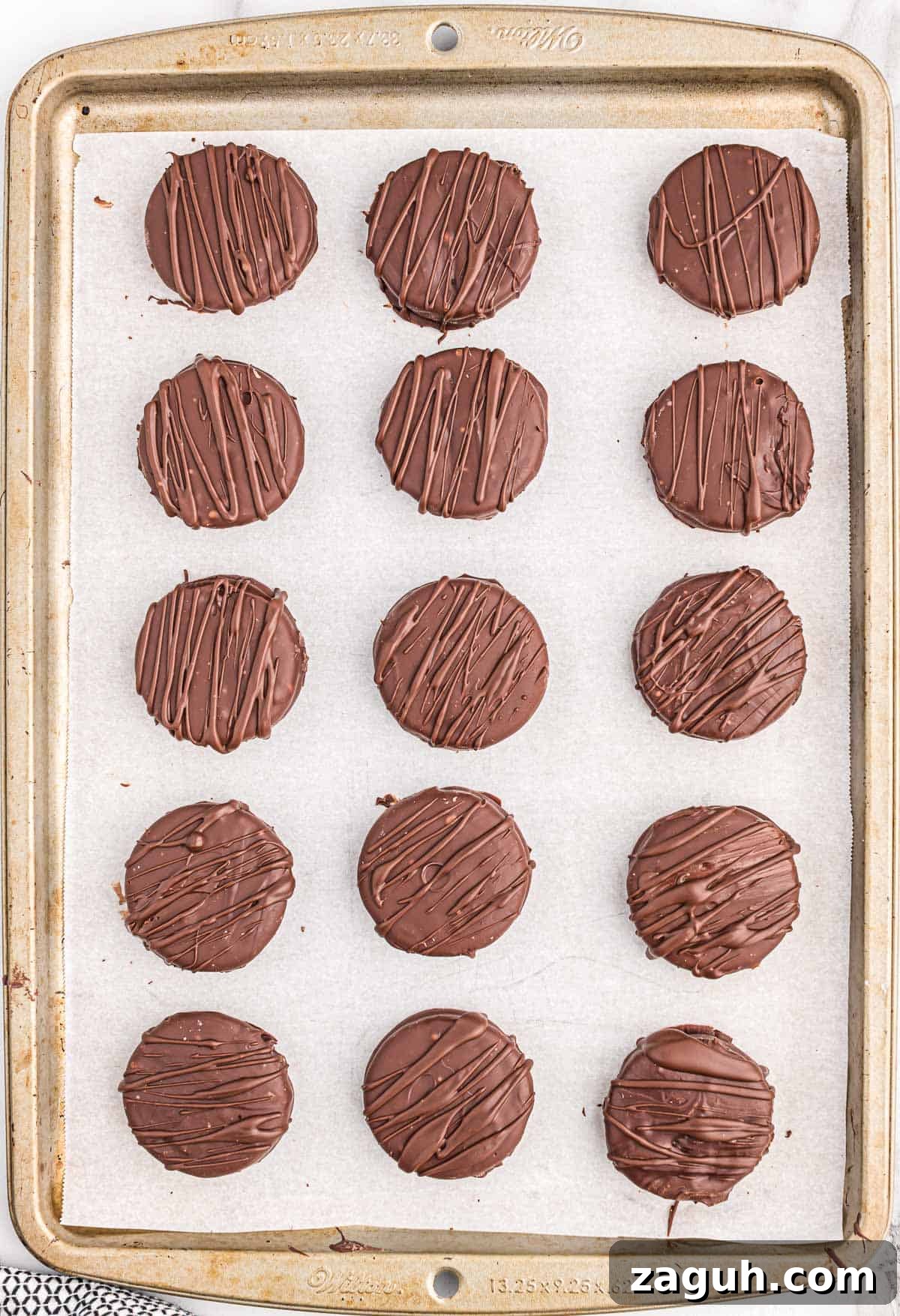 How to Make Chocolate-Covered Oreos at Home 7 chocolate drizzled oreos on a baking sheet