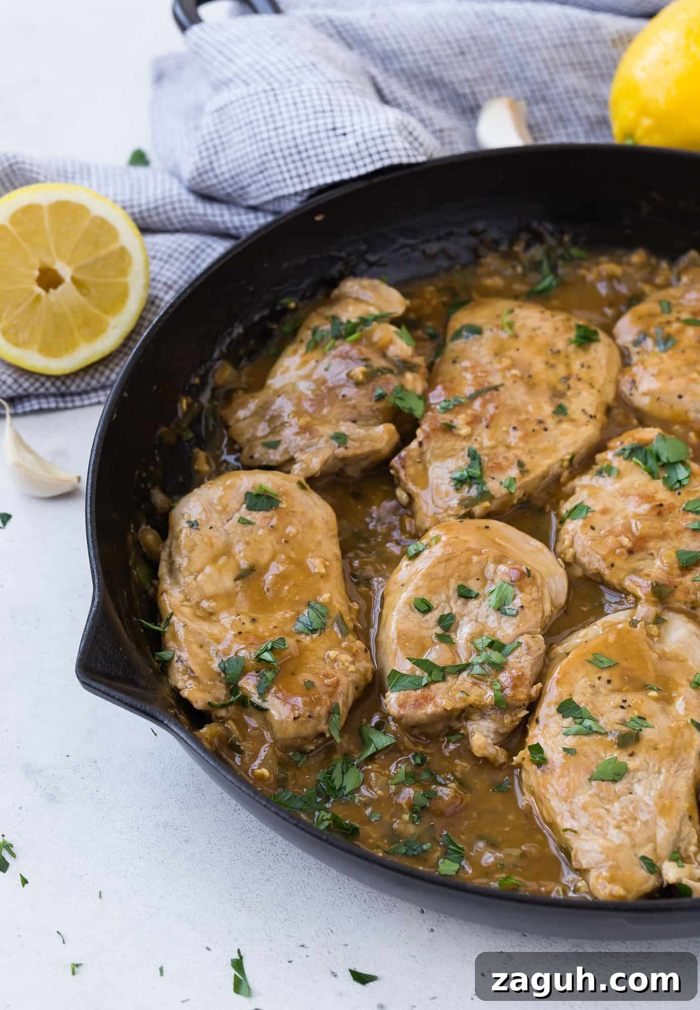 Lemon Garlic Pork Medallions with Creamy Pan Sauce 3 Pork with lemon garlic sauce garnished with parsley.