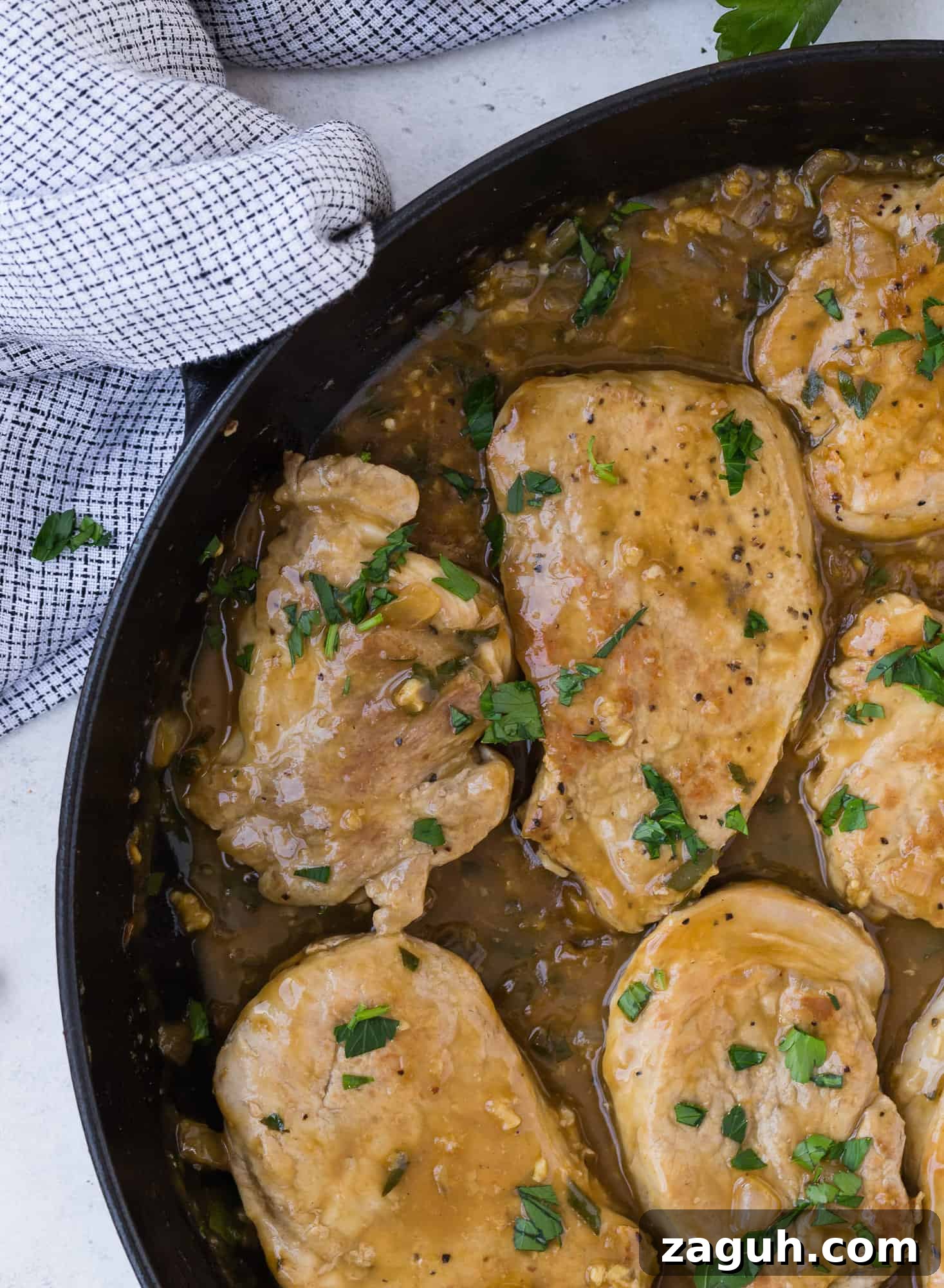 Lemon Garlic Pork Medallions with Creamy Pan Sauce 5 Pork with light brown sauce and parsley.