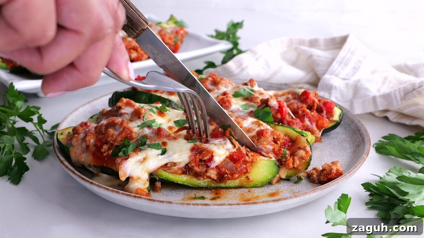 Turkey-Stuffed Zucchini Boats Recipe for Weeknight Dinners 5 Person cutting into stuffed zucchini boats