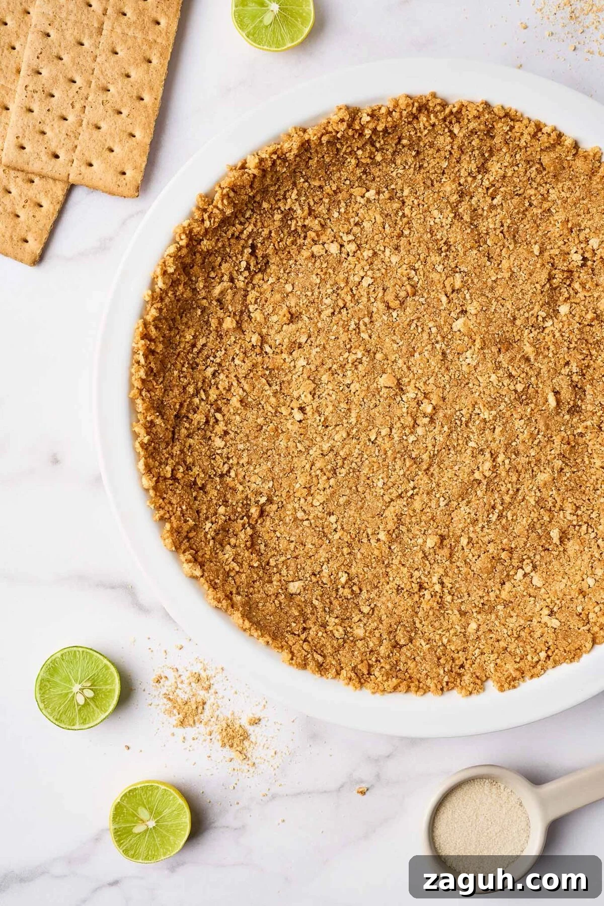 Graham cracker crust pressed into pie plate for Florida Key lime pie, ready to bake.