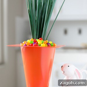 Use an orange traffic cone to make a Giant Carrot Centerpiece for the Easter table! This dollar store centerpiece is filled with Jelly Beans!