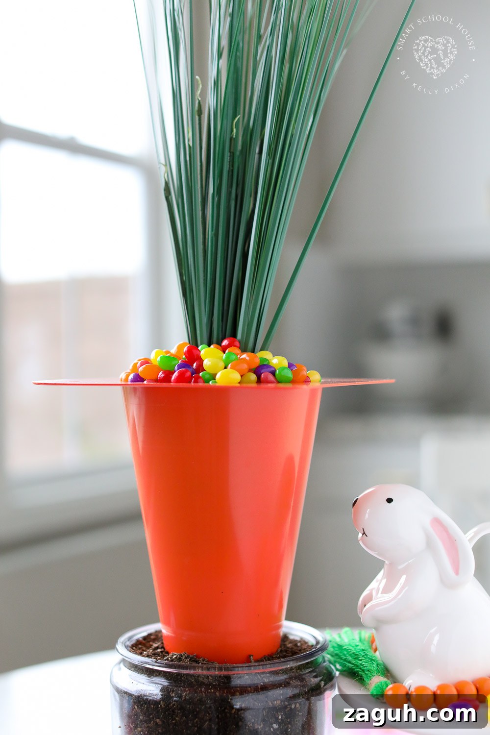 Use an orange playground cone to make a Giant Carrot Centerpiece for the Easter table! This dollar store centerpiece is filled with Jelly Beans!