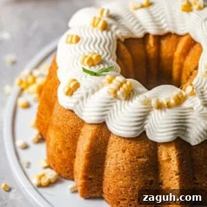 Moist Corn Pound Cake Recipe with Creamy Cornmeal Crumble 16 overhead photo of corn pound cake on a cake plate with honey buttercream on top.