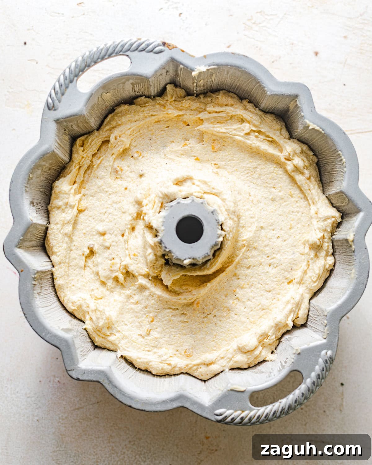 Moist Corn Pound Cake Recipe with Creamy Cornmeal Crumble 8 corn cake batter in a bundt pan.