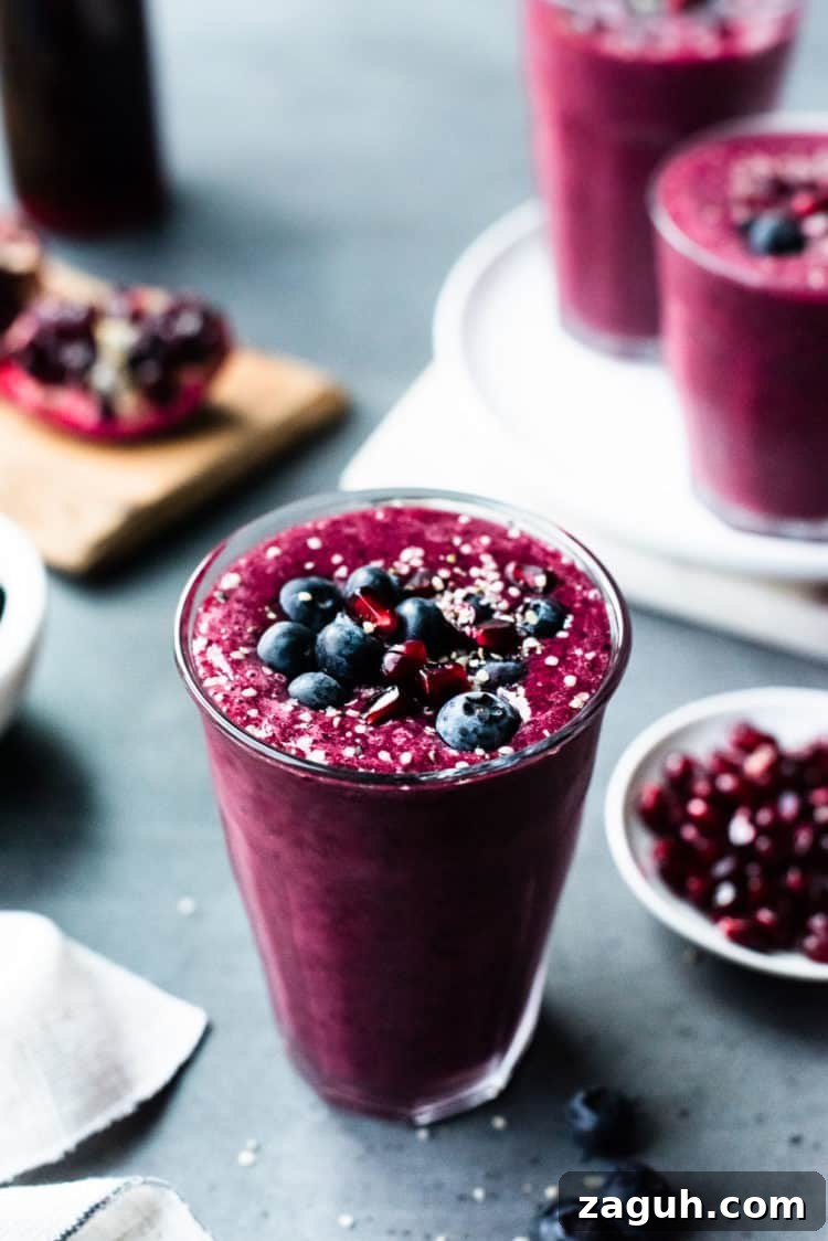 Pomegranate Berry Smoothie Recipe for Fresh Antioxidant Boost 4 Pomegranate Berry Smoothie topped with blueberries, pomegranate arils and hemp seeds.
