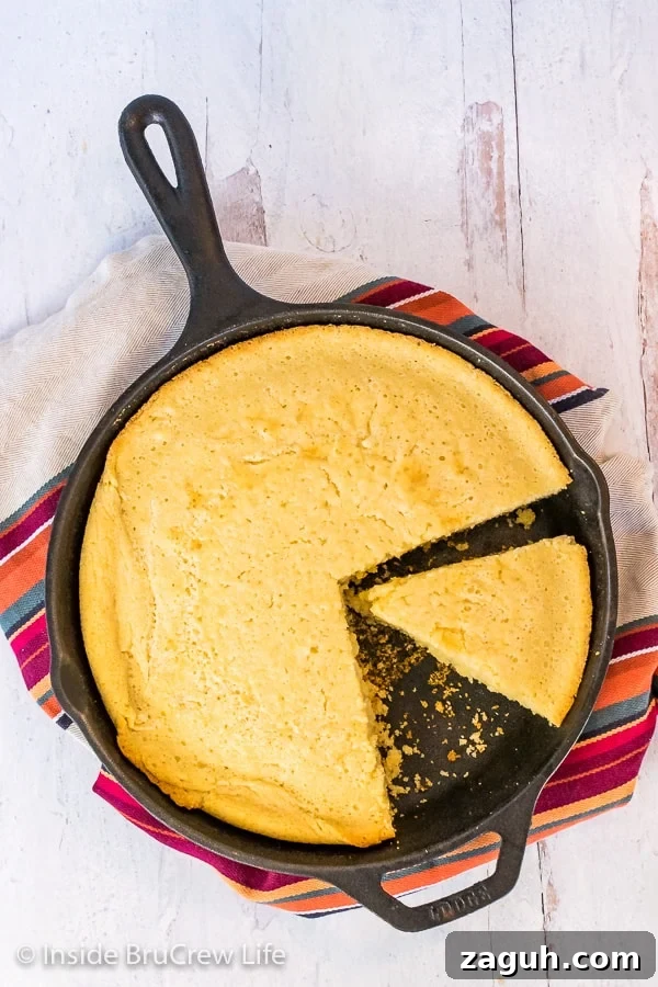 Easy Skillet Cornbread - this cornbread is easy to make in minutes with ingredients from your pantry. Make and serve this recipe with chili, soup, or pork. Overhead picture of a cast iron skillet with easy cornbread in it