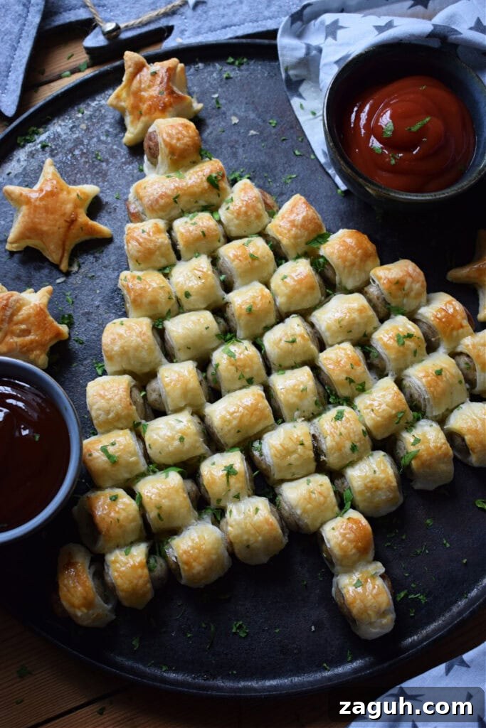 Festive Sausage Roll Christmas Tree Recipe Tutorial 3 A sausage roll Christmas tree on a tray with dips.