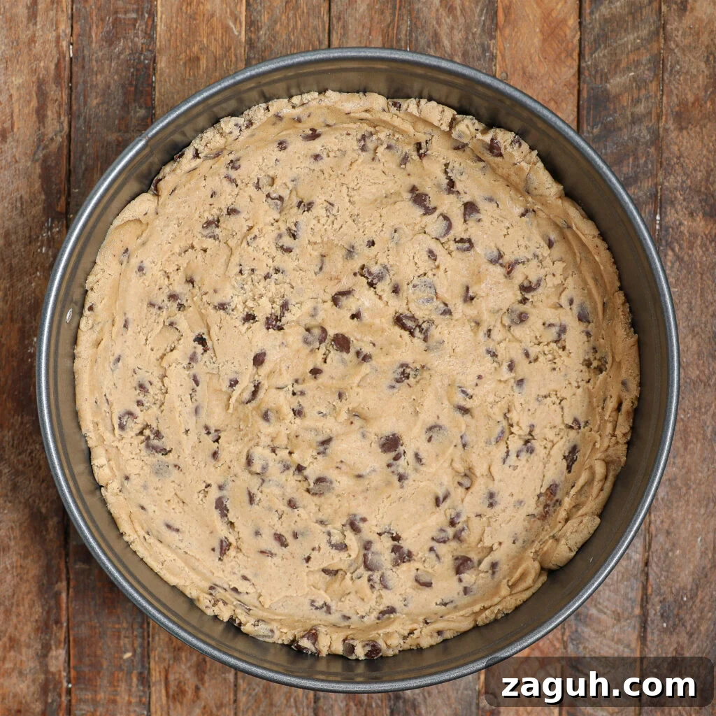 Cookie Dough Cheesecake Recipe: Creamy No-Bake Dessert with Edible Dough 3 Pressing cookie dough into pan