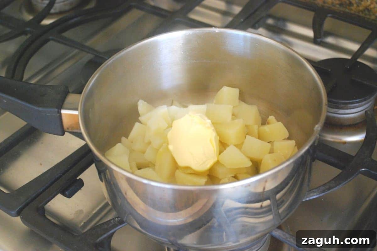 Ultimate Thanksgiving Casserole: One-Pan Holiday Dinner Recipe 3 potatoes in a sauce pan with butter.