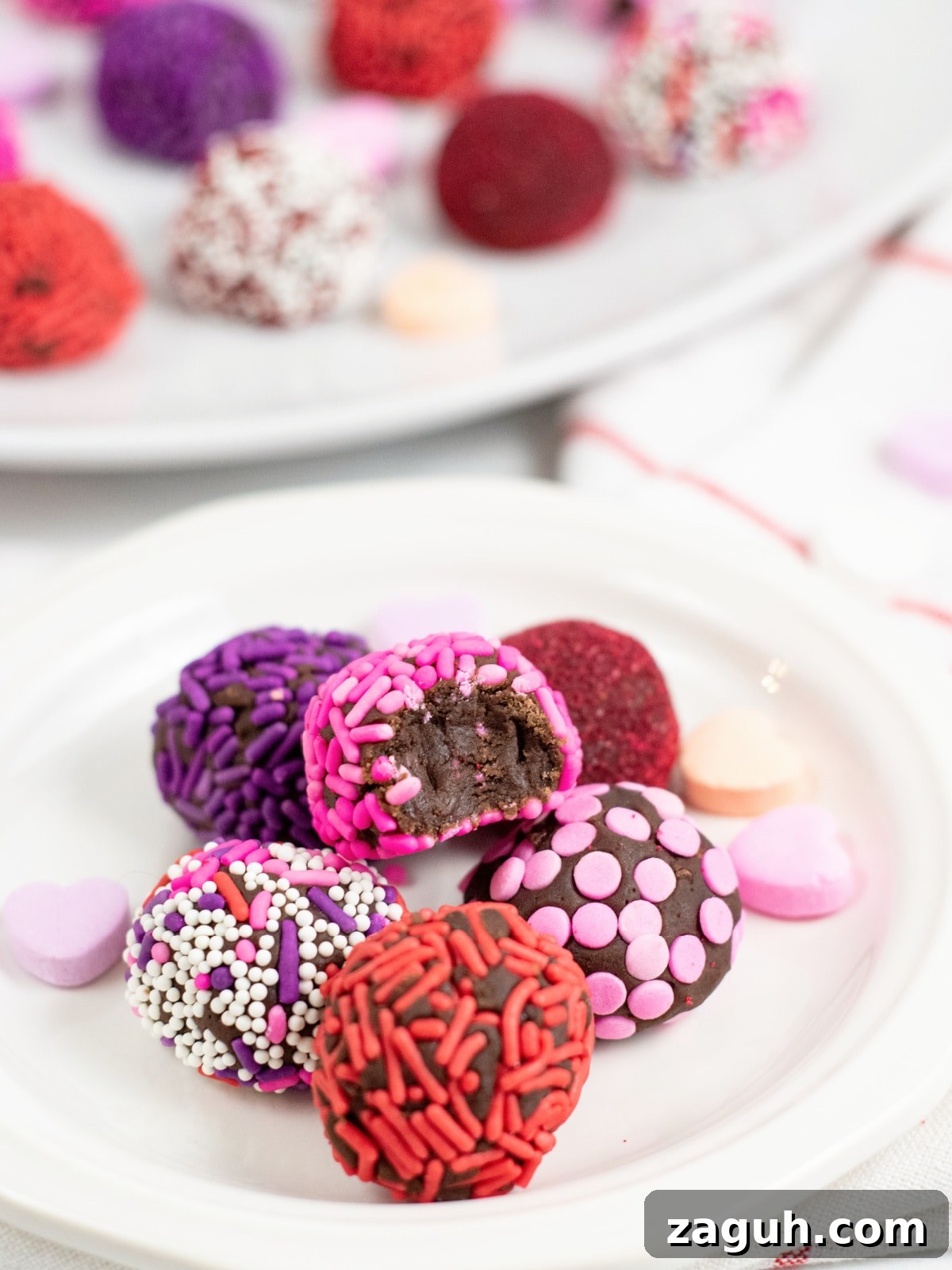 Valentine’s Day No-Bake Chocolate Brownie Bites 2 Valentine's Brownie Truffles on a White Plate
