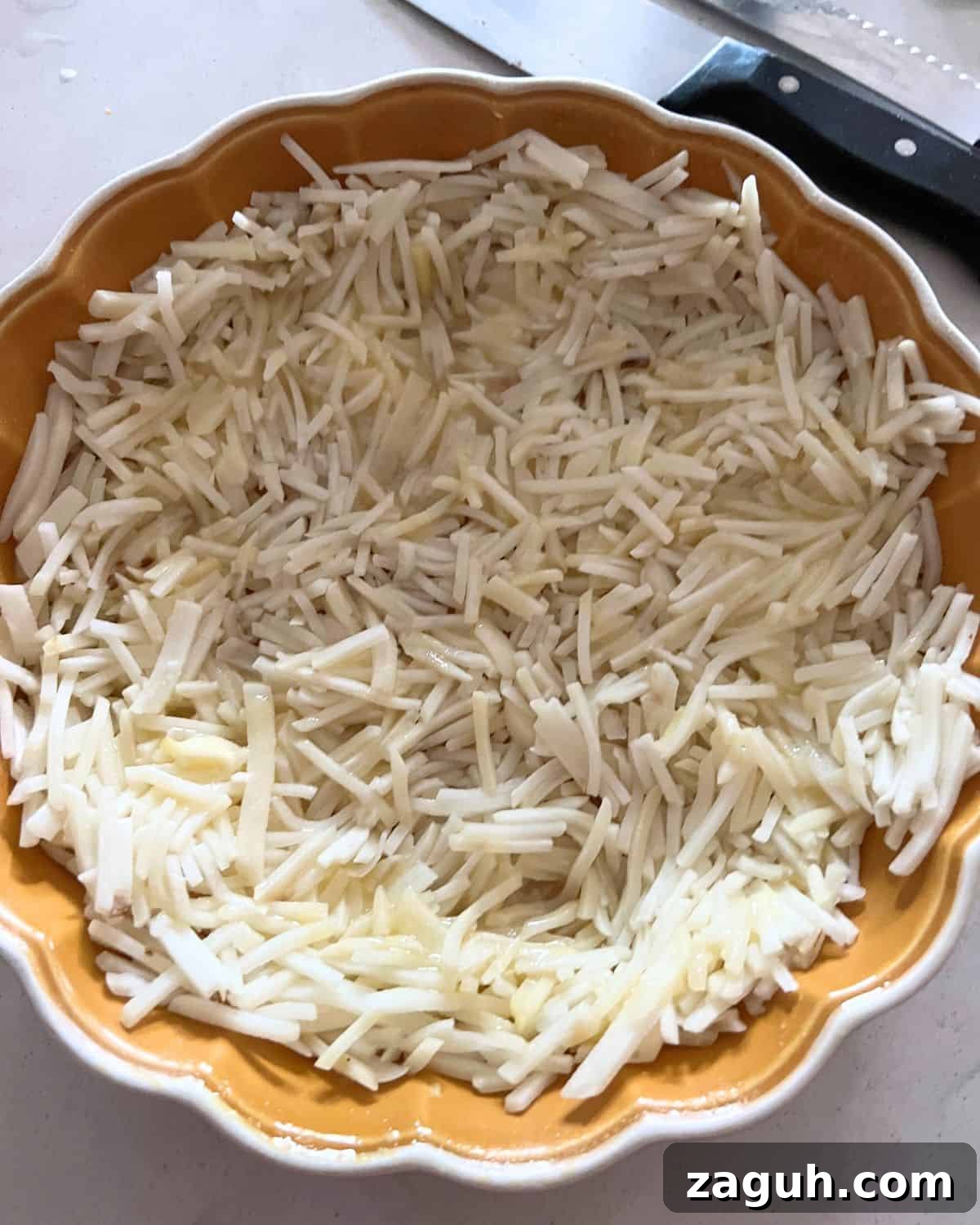 Paula Deen’s Cheesy Hash Brown Quiche Recipe 4 Hash browns crust in a pie dish.