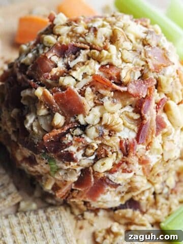 Bacon and walnut covered cheese ball served with crackers, celery, and carrots.