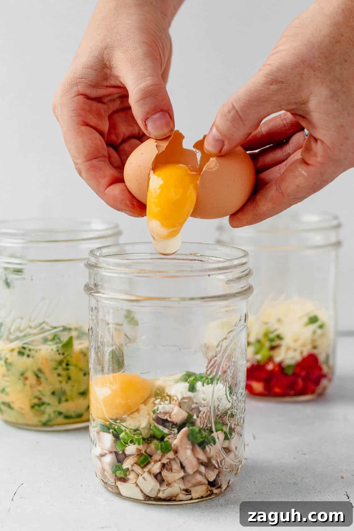 Perfectly Fluffy Scrambled Eggs in the Air Fryer 4 cracking an egg in a mason jar